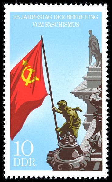 Stamp from the former DDR (East Germany) depicting the Soviet flag being hoisted 9on the Reichstag