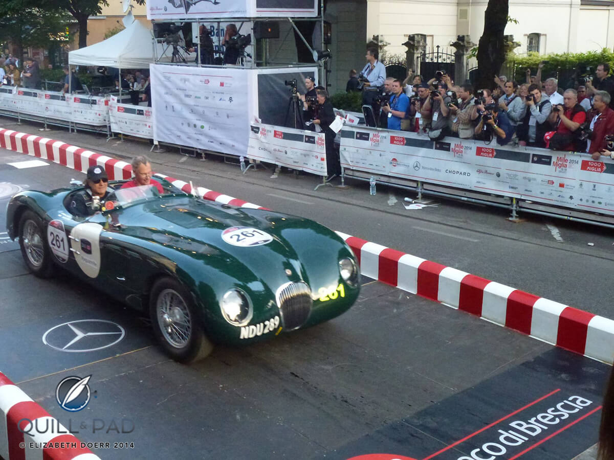 AC/DC singer Brian Johnson and co-driver Mark Dixon crossing the start line of the 2014 Mille Miglia in a 1953 Jaguar C-Type