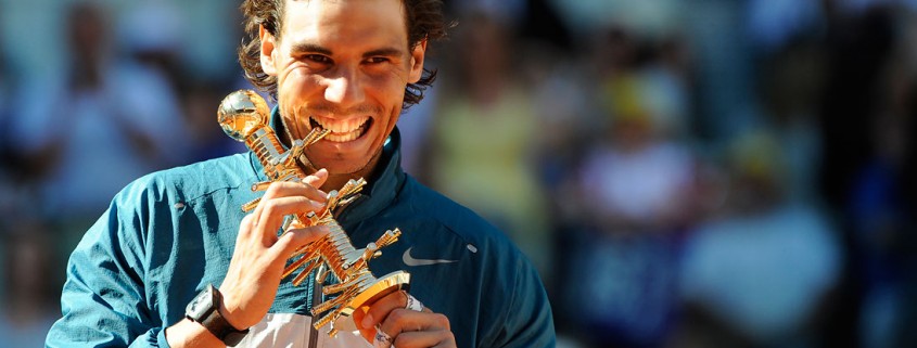 A very pleased Rafael Nadal with the Ion Tiriac Trophy after winning the 2014 Mutua Madrid Open . Phozo courtesy ATP