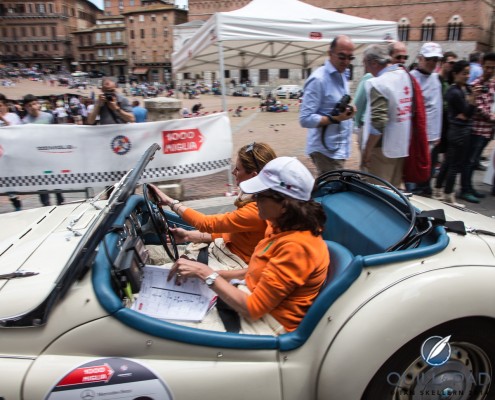 Trinetta bas van Oisen and Ant bas van Broek driving a 1955 Triumph TR 2 Sports into Siena during the 2014 Mille Miglia