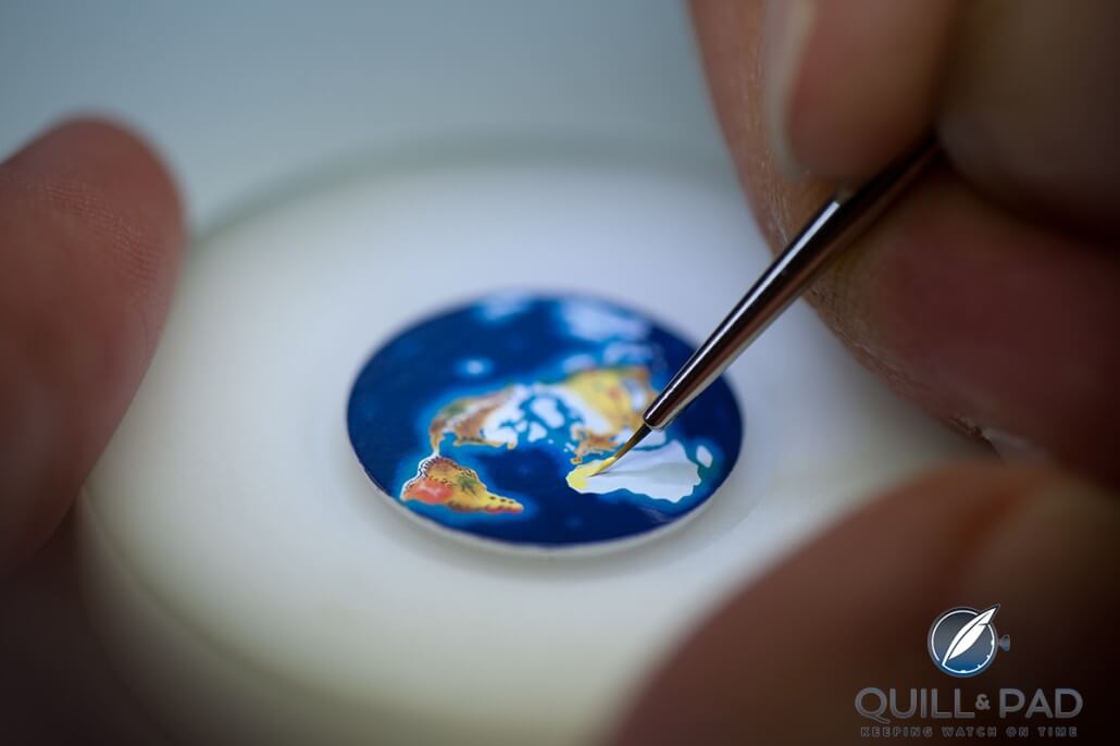Hand painting the enamel Earth dial of a Ulysse Nardin Moonstruck