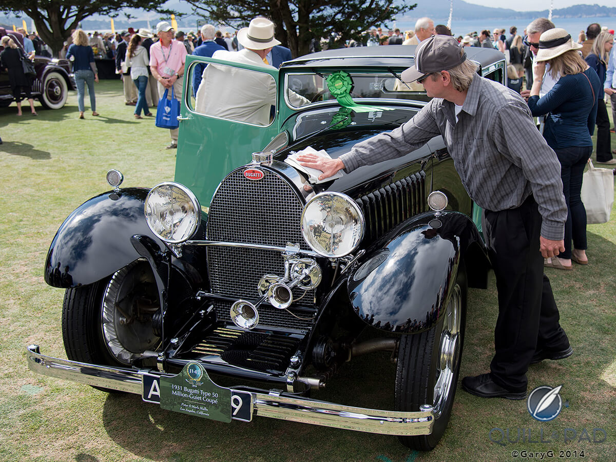 Perfecting perfection: a quick swipe of the cloth on a 1931 Bugatti coupe