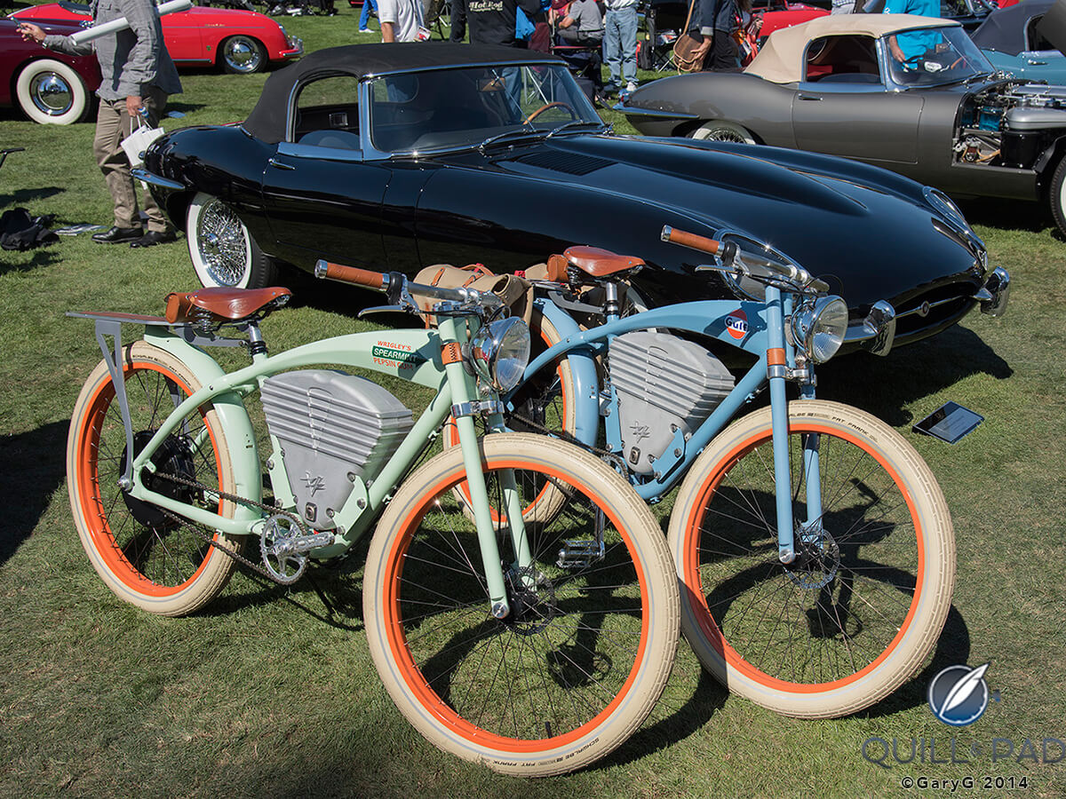 Vintage motorbikes with two of the many Jaguar E-Types at The Quail A Motorsports Gathering