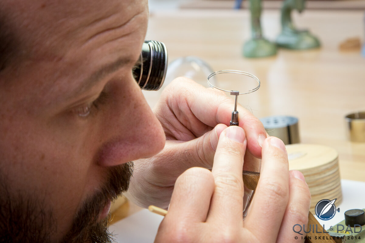 Watchmaker carefully inspecting a minute repeater cathedral gong at La Fabrique du Temps Louis Vuitton