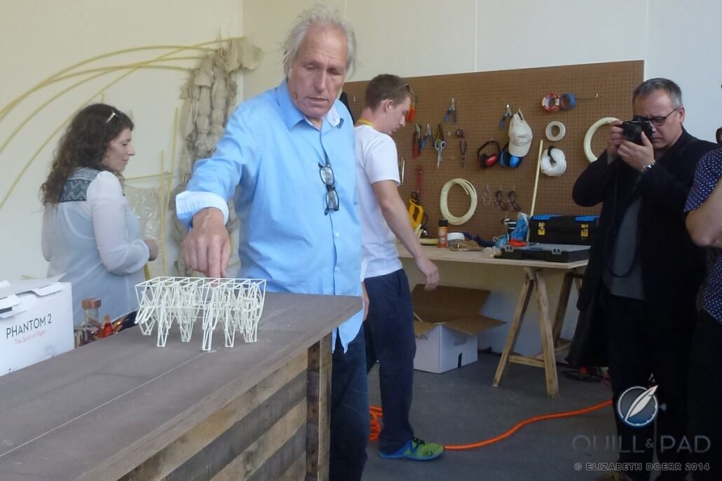 Theo Jansen using a 3D-printed model made by one of his admirers to show another way of how the Strandbeests could walk