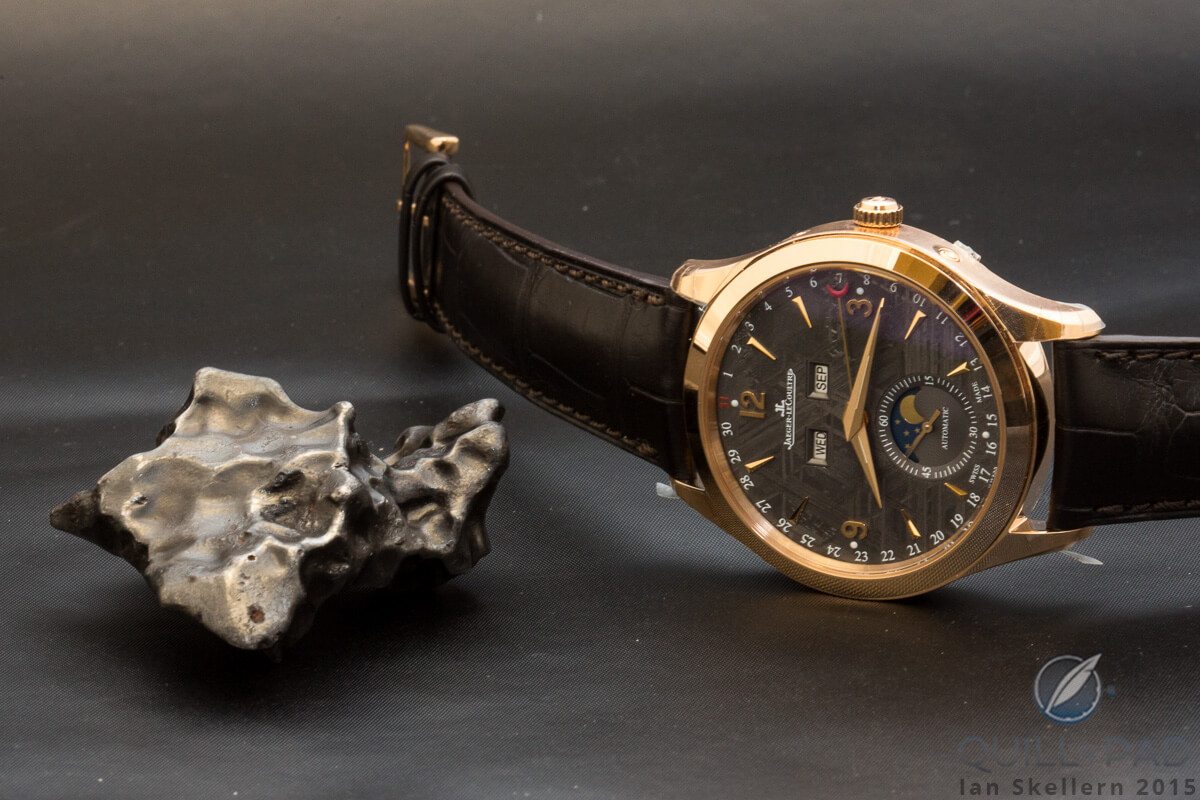 Jaeger-LeCoultre Master Calendar with meteorite dial beside a genuine meteor fragment