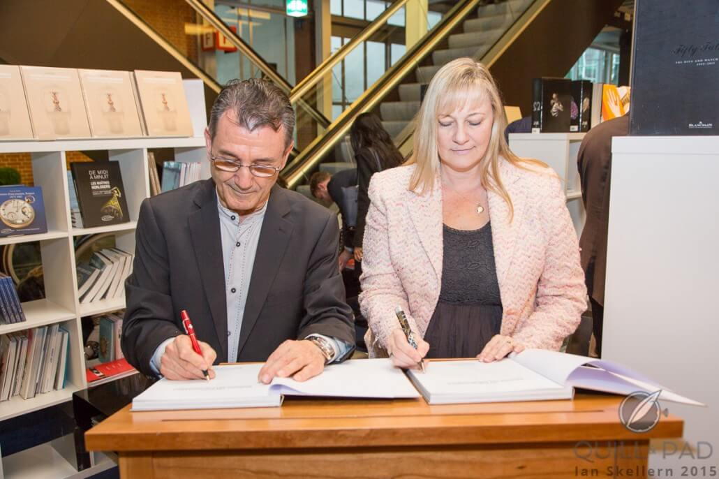 Elizabeth Doerr and Vincent Calabrese signing the book released at Baselworld tracing the story of Corum's Golden Bridge