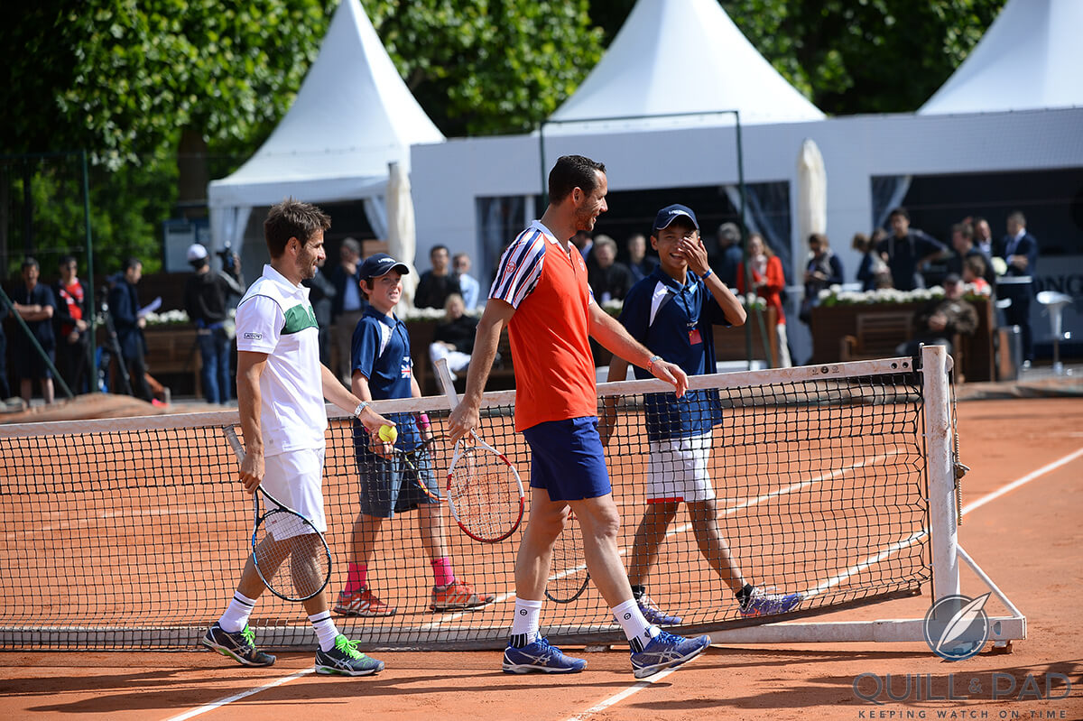 Xiaofei Wang and Jack Pinnington-Jones (far side of the net) playing an exhibition match at Roland Garros with French Davis Cup captain Arnaud Clément and 2007 Wimbledon doubles champion Michaël Llodra