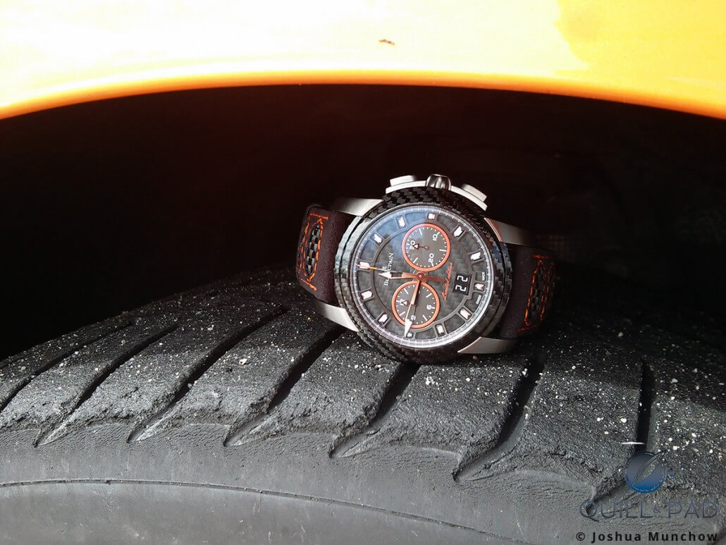 The limited edition Blancpain L-evolution R Chronograph Flyback Grand Date resting on the tire of a Lamborghini Huracan