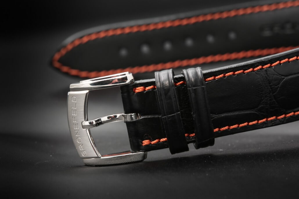 The bright red stitching against the black leather of the strap makes for a stunning backdrop to the brightly polished platinum buckle