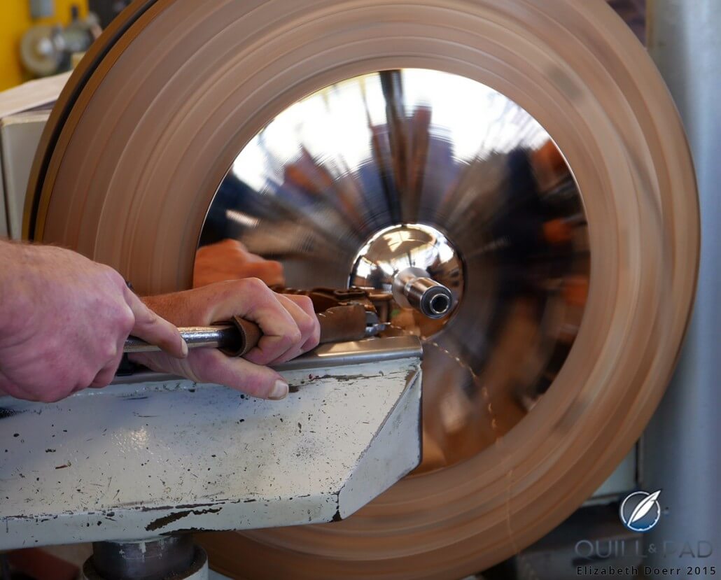A craftsman taking metal from a Paiste cymbal in progress with a lathe at the Lucerne factory