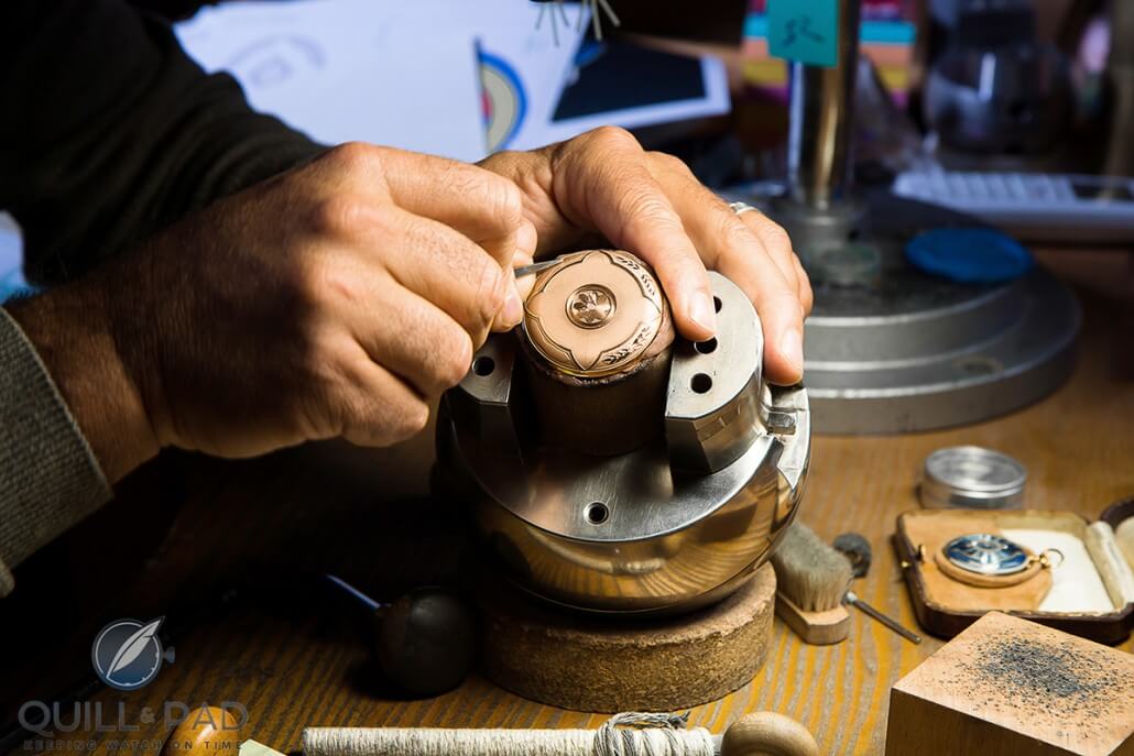 Craftsman engraving the cover of the H. Moser & Cie Endeavour Perpetual Calendar Heritage Limited Edition