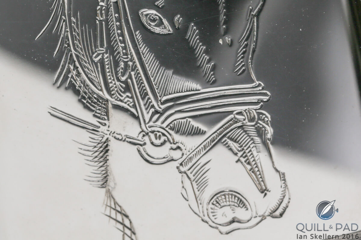 Close up look at the details in the engraving of Gucci on the back of a Jaeger-LeCoultre