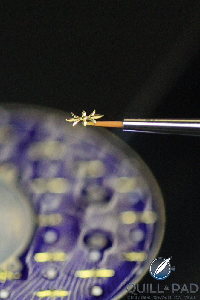 A sculptured single gold paillonnée being placed on the Jaquet Droz dial