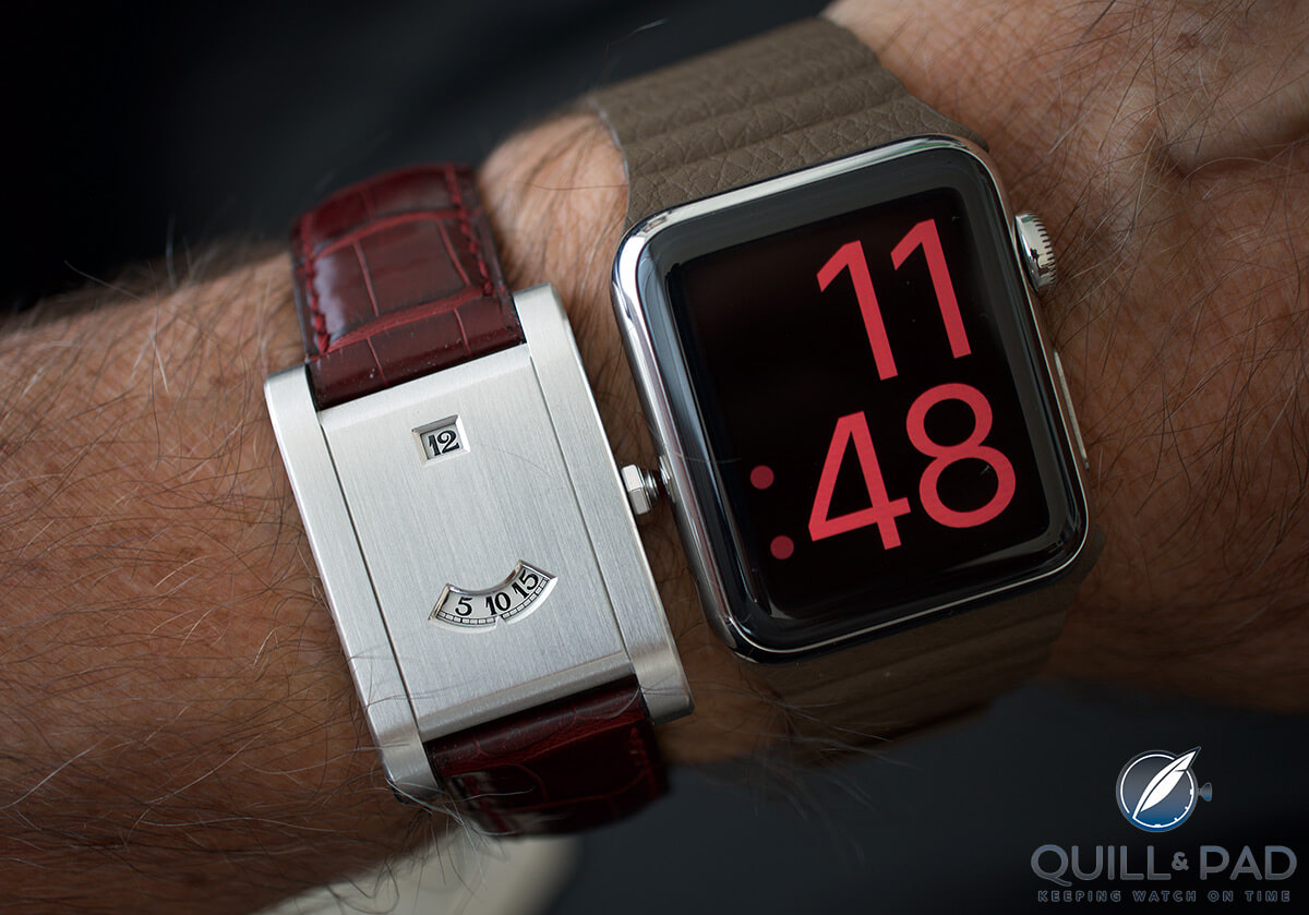 Two digital watches compared on the wrist: Cartier Tank à Guichets and Apple Watch