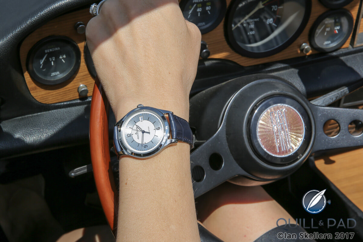 Nola at the wheel wearing a Jaeger-LeCoultre Master Control Date 