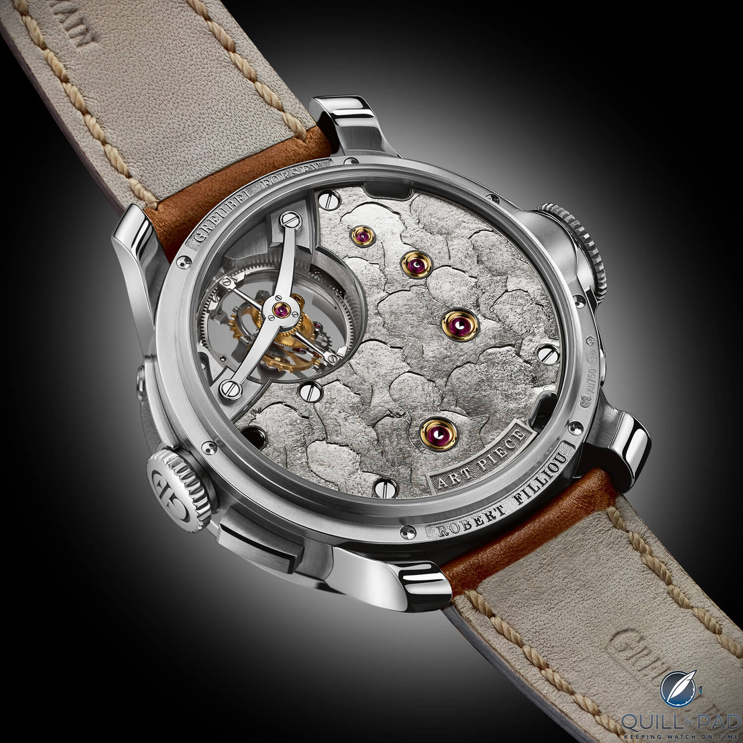 The back of the watch is decorated with profiles of those involved in the Greubel Forsey Art Piece 2 Edition 1 Filliou project, a reference to Filliou’s Couvre-Chef(s)-D’oeuvre(s), depicting a bowler hat containing the works of 14 artists