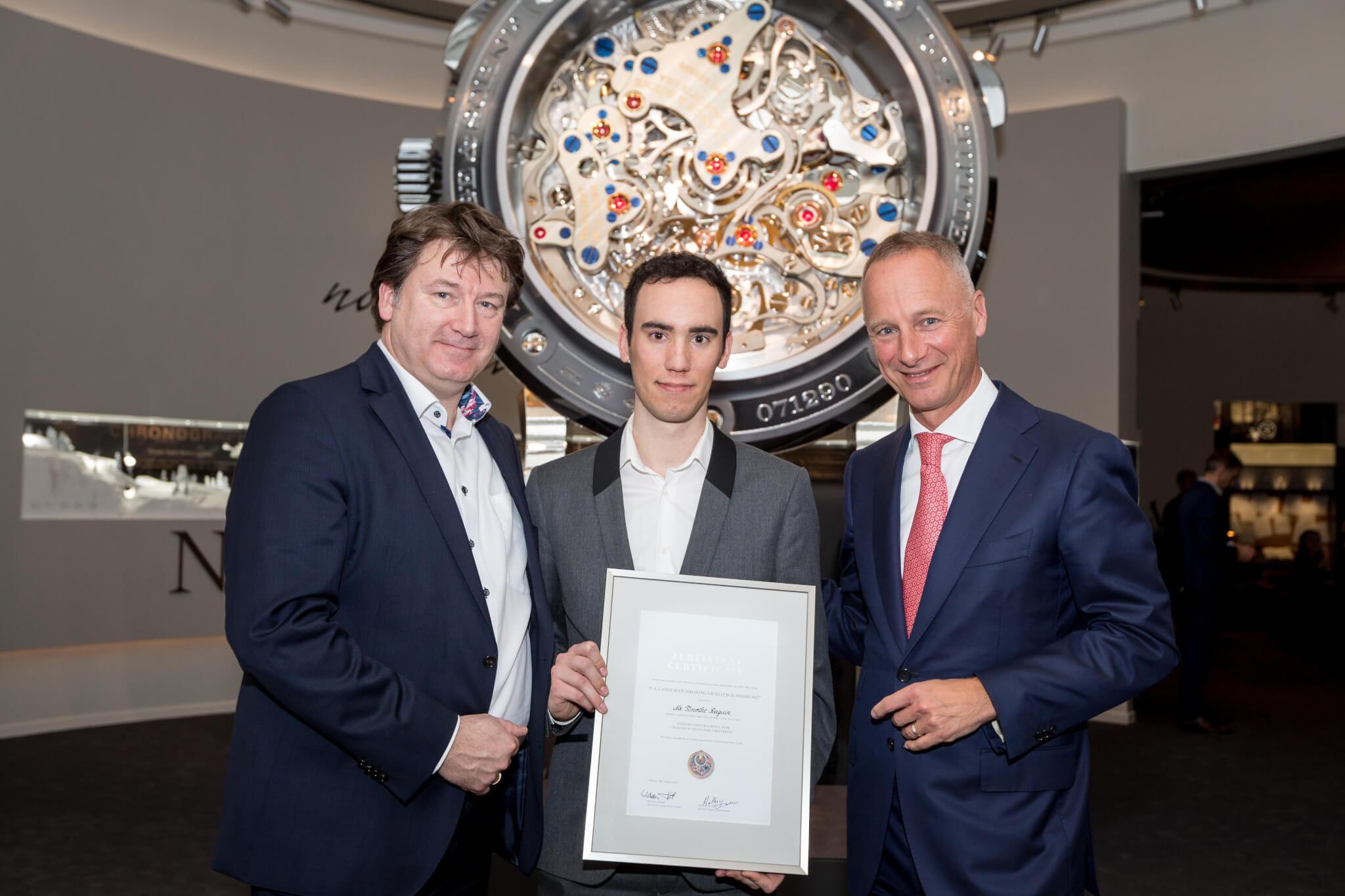 Timothé Raguin (center) with his F.A. Lange Watchmaking Excellence Award 