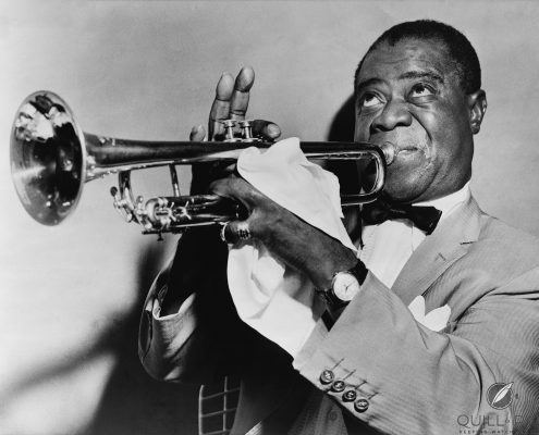 Louis Armstrong playing trumpet in 1953, wearing his prized gold wristwatch