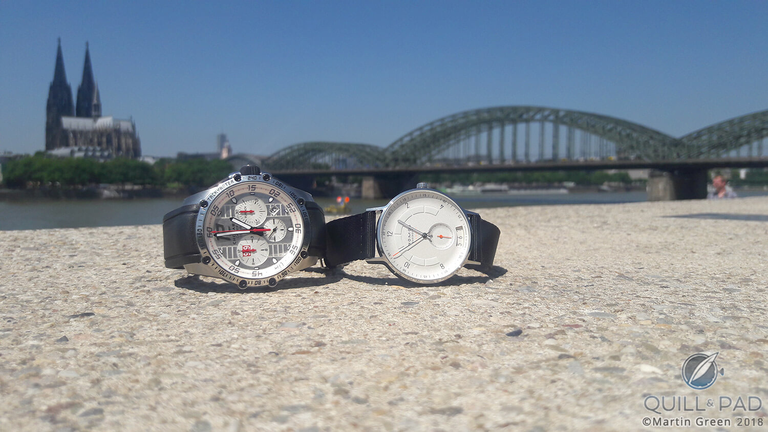 The Chopard Superfast Chrono Porsche 919 Edition and the Nomos Glashütte Autobahn with the Cologne’s cathedral and the Deutz bridge in the background