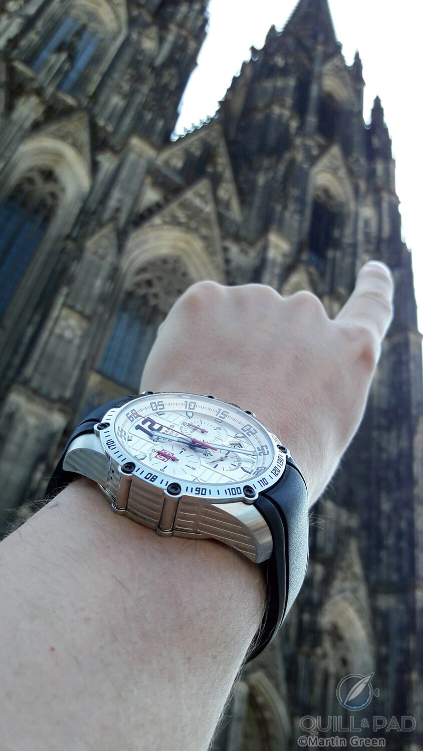 Two highly noticeable objects: the Chopard Superfast Chrono Porsche 919 Edition and the Cologne Cathedral