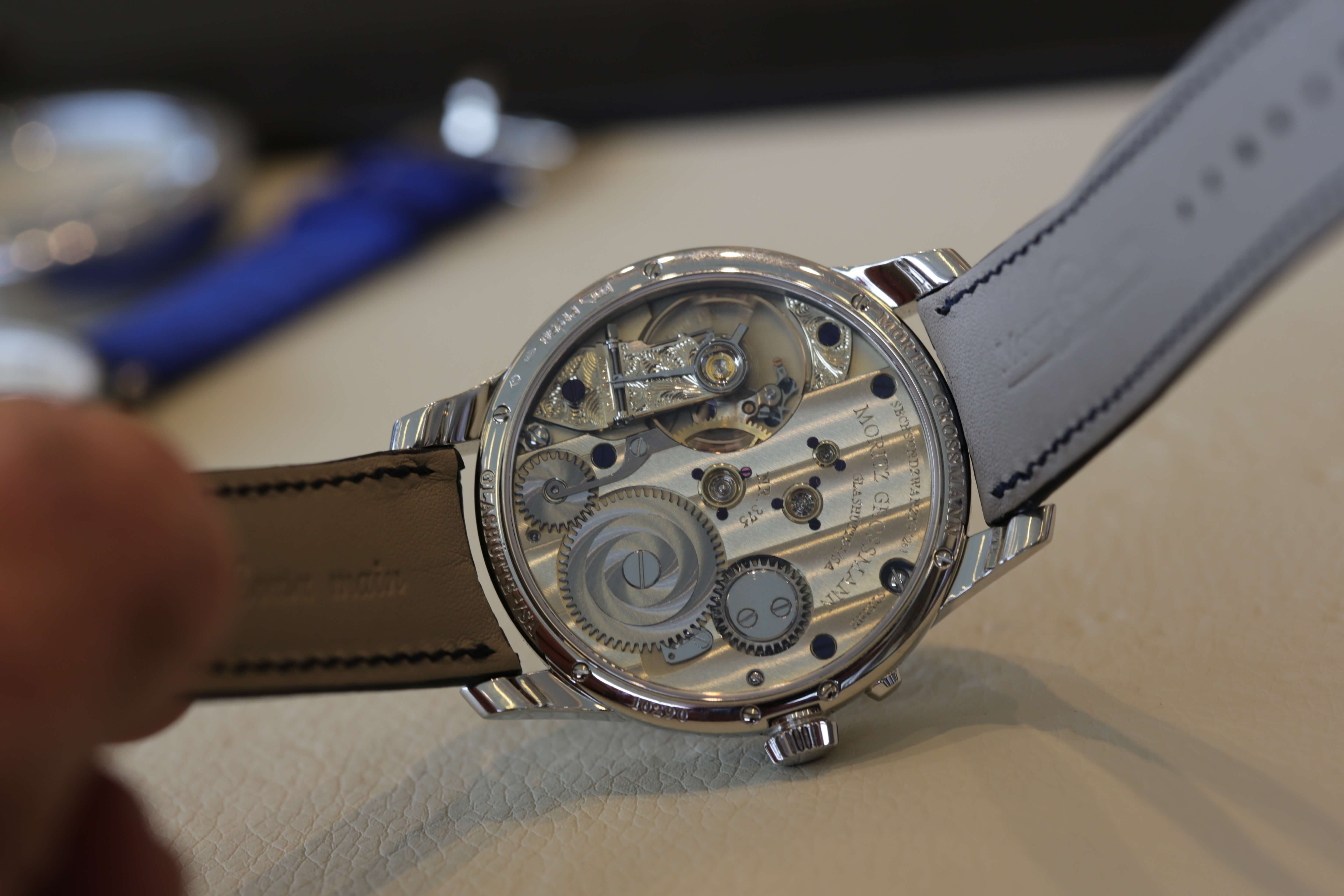 Impeccably hand finished Moritz Grossmann movement visible through the display back