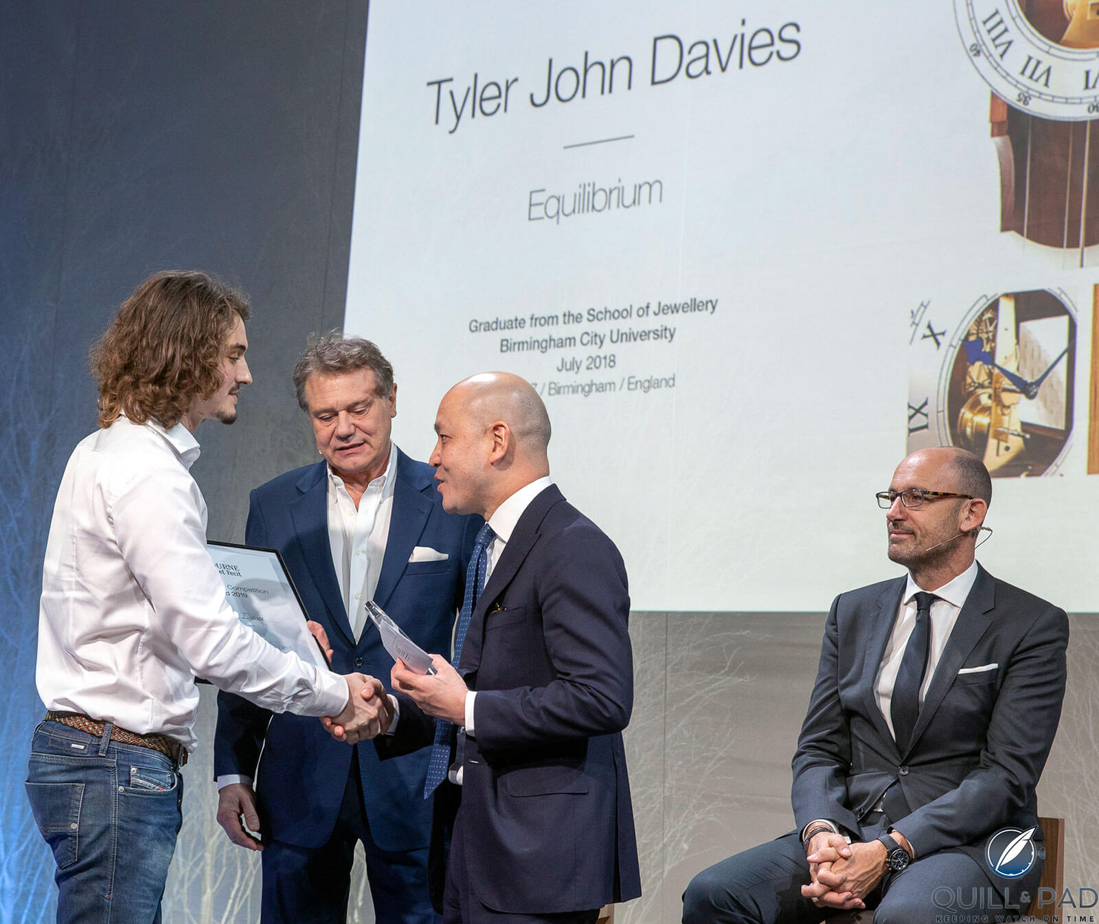 Tyler John Davies (left) receiving F.P. Journe Young Talent Competition 2019 award for his Equilibrium clock from François-Paul Journe and Michel Tay
